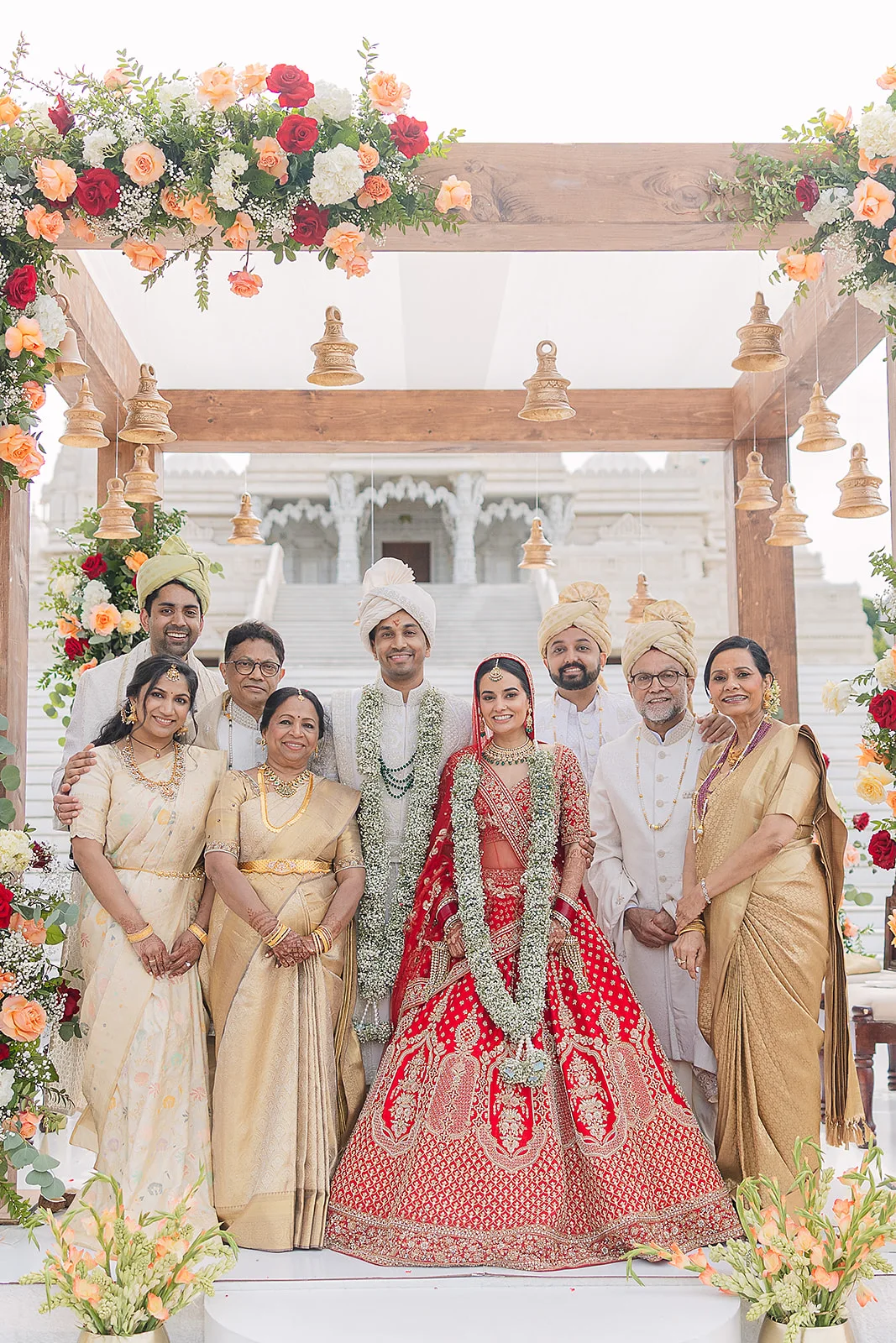 Bride and family beneath a floral wedding canopy